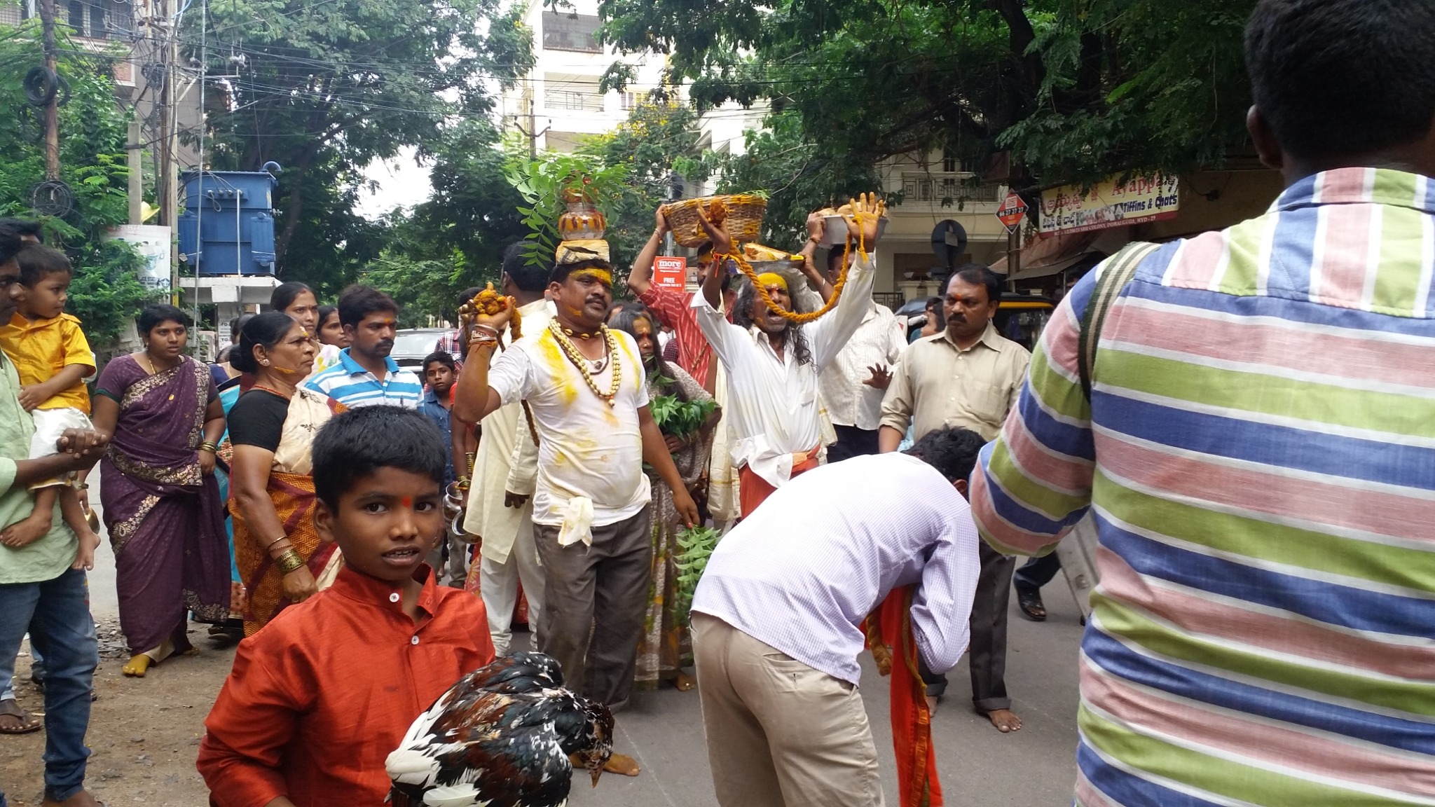 Families and devotees participating together in the temple procession