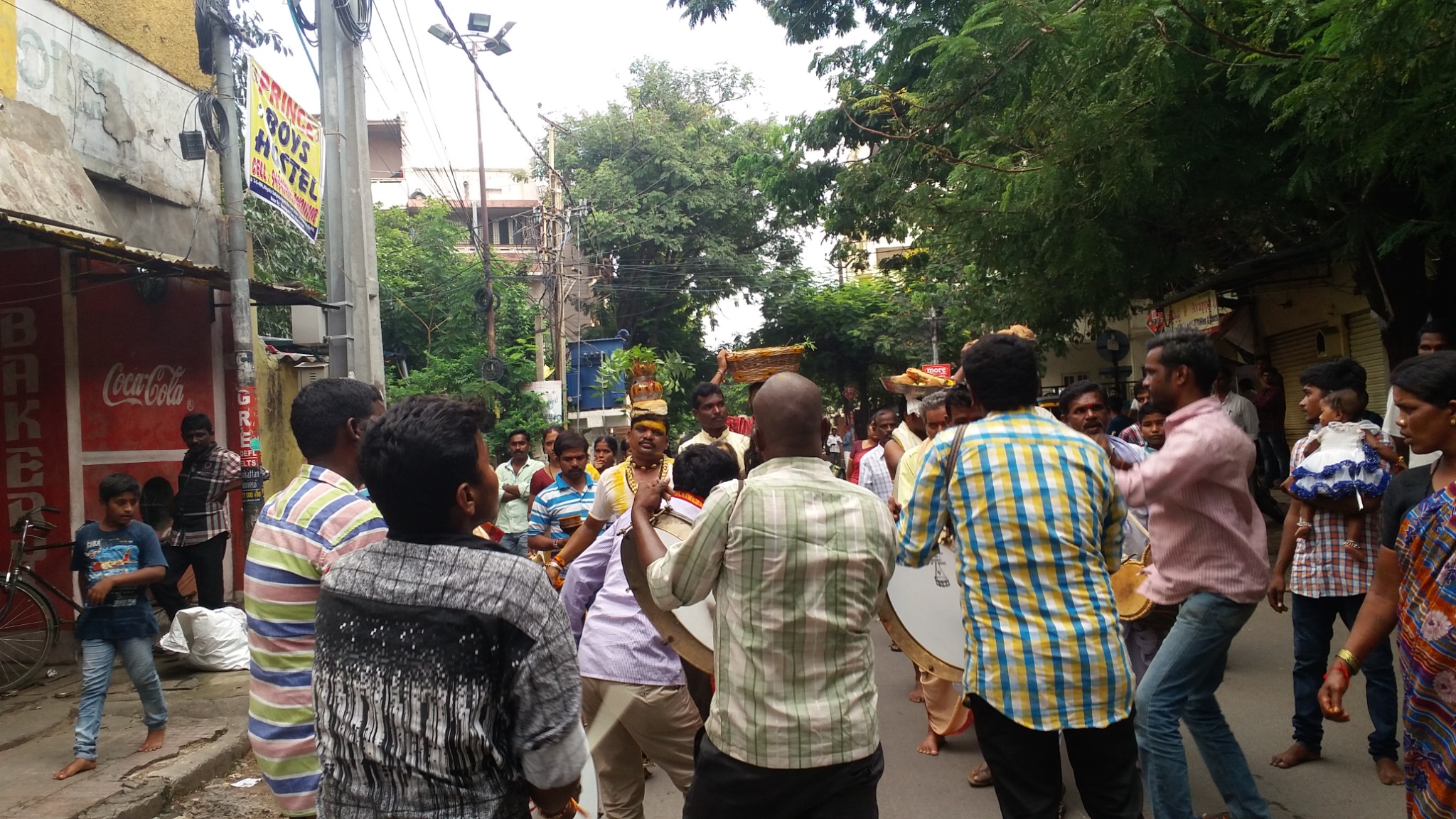A wide view of the traditional procession through the temple neighbourhood