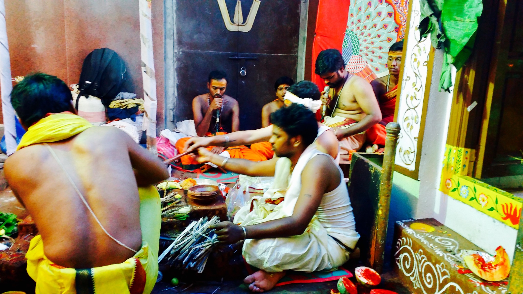 Family members and priests participating in traditional temple prayers